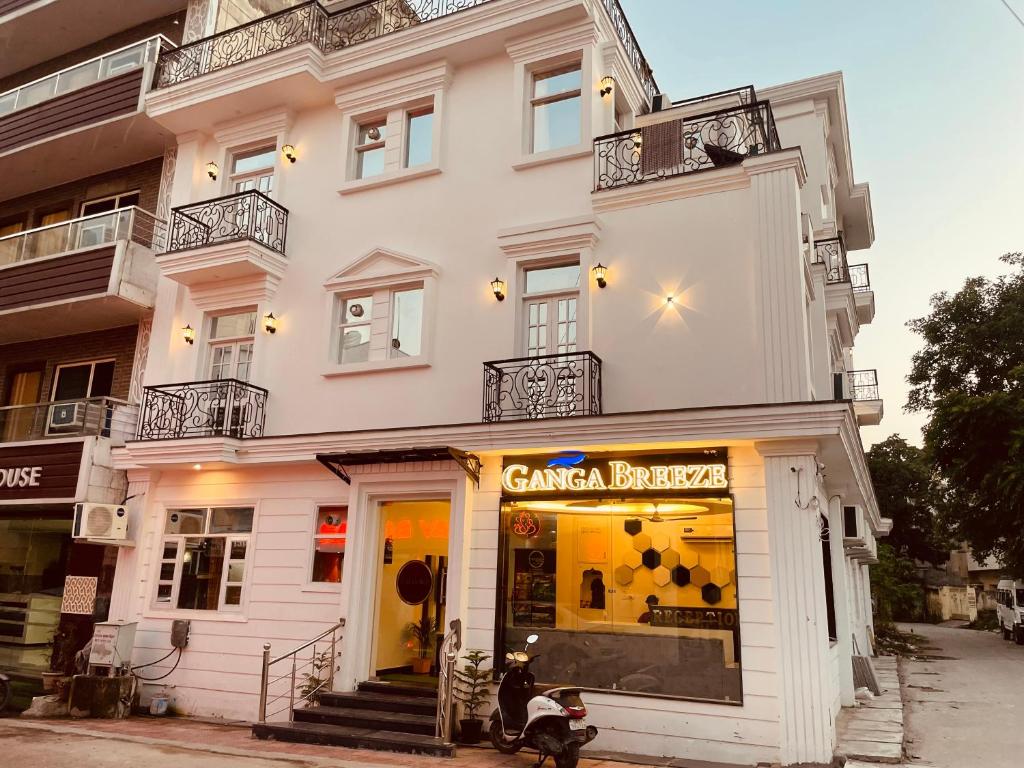 a white building with a store in front of it at The Divine Ganga - Top Rated and Most Awarded Property In Haridwar in Haridwār