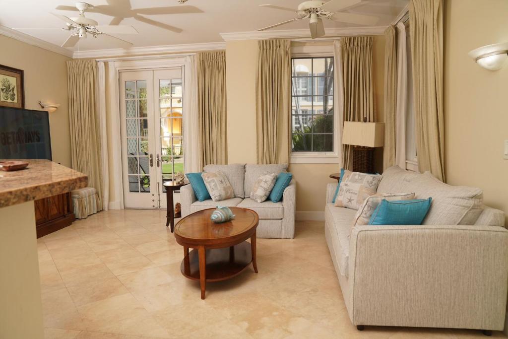a living room with a couch and a table at Villa Renaissance Unit 501 Grace Bay Beach in The Bight Settlements