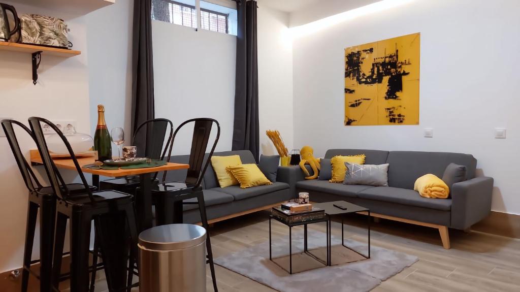 a living room with a couch and a table at Aparthotelmadridea, renovated quiet apartments, Madrid in Madrid