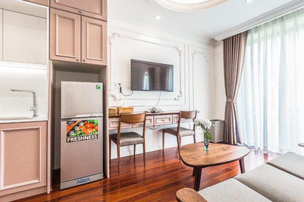 a living room with a refrigerator and a table at Ngan Ha 2 Apartments in Ho Chi Minh City