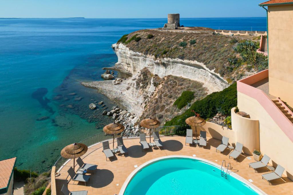an aerial view of a resort with a pool and the ocean at Hotel La Baja in Santa Caterina
