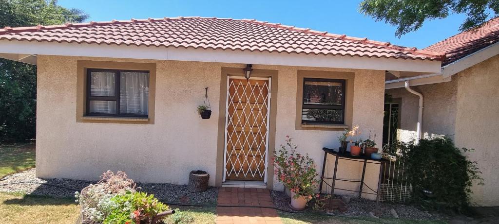 a small house with a gate in front of it at Cottage on Kei in Germiston