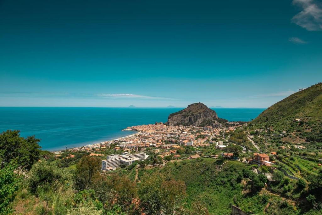 a view of a town on a hill next to the ocean at Mimosa in Cefalù