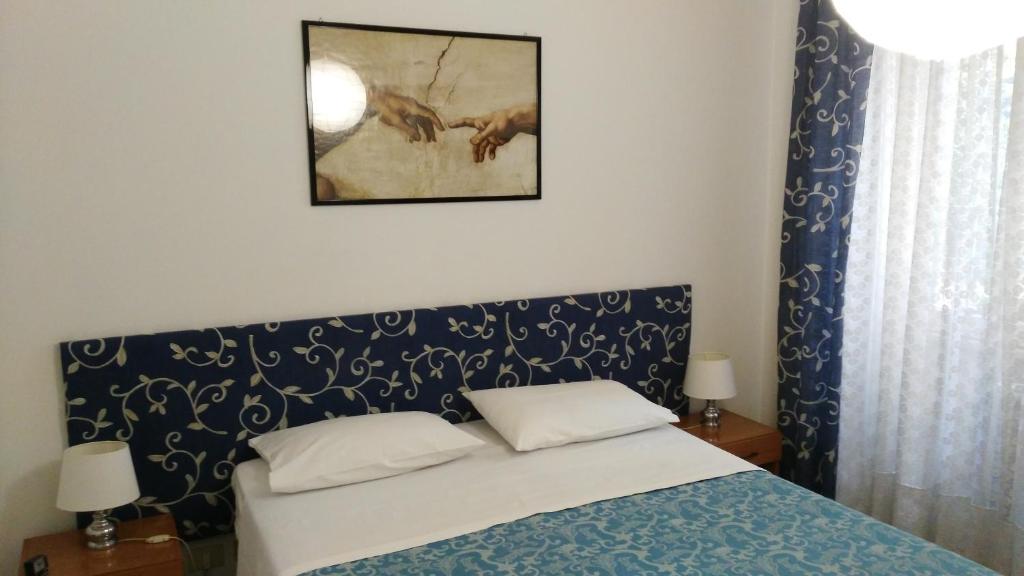 Postel nebo postele na pokoji v ubytování Trionfal Apartment