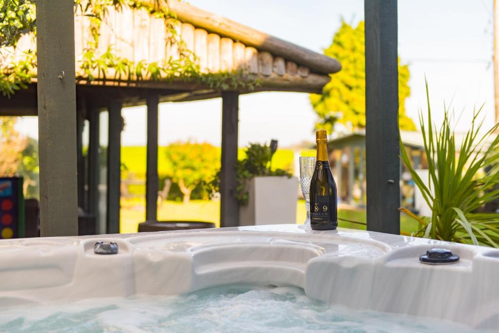 a bottle of wine sitting in a hot tub at Channel View by Bloom Stays in Folkestone