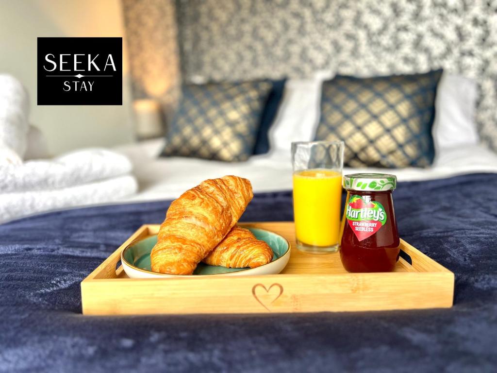 a tray with a plate of croissants and a glass of ketchup at Cosy 2-bedroom house, Walking distance CBS, Ideal for contractors-business stays in Coventry
