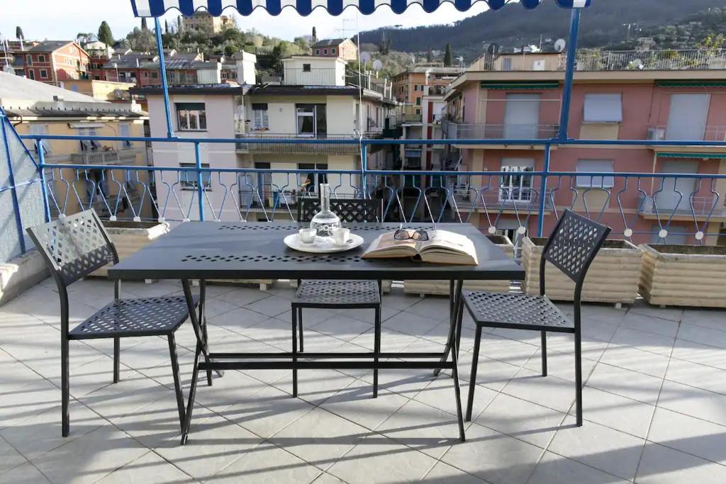 a table and chairs on the roof of a building at CasaViva - Blue Penthouse with parking in Santa M in Santa Margherita Ligure