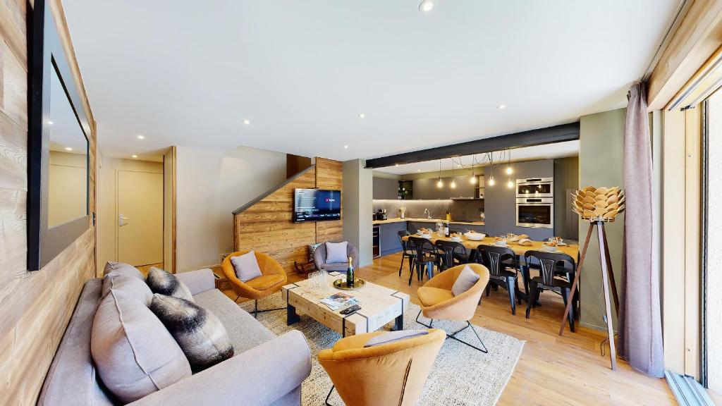 a living room with a couch and a table at Nouveau ! Chalet pied des pistes in Champagny-en-Vanoise