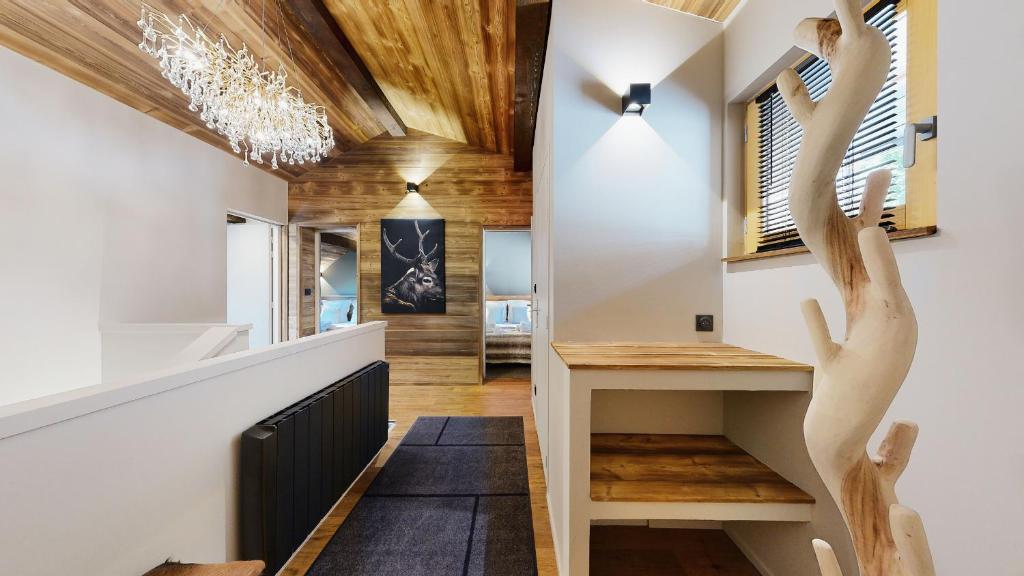 a hallway with wooden floors and a staircase with wooden hands on the wall at Nouveau ! Chalet pied des pistes in Champagny-en-Vanoise