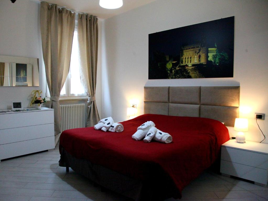 two hello kitty towels on a red bed in a bedroom at RB Della Torre in Porretta Terme