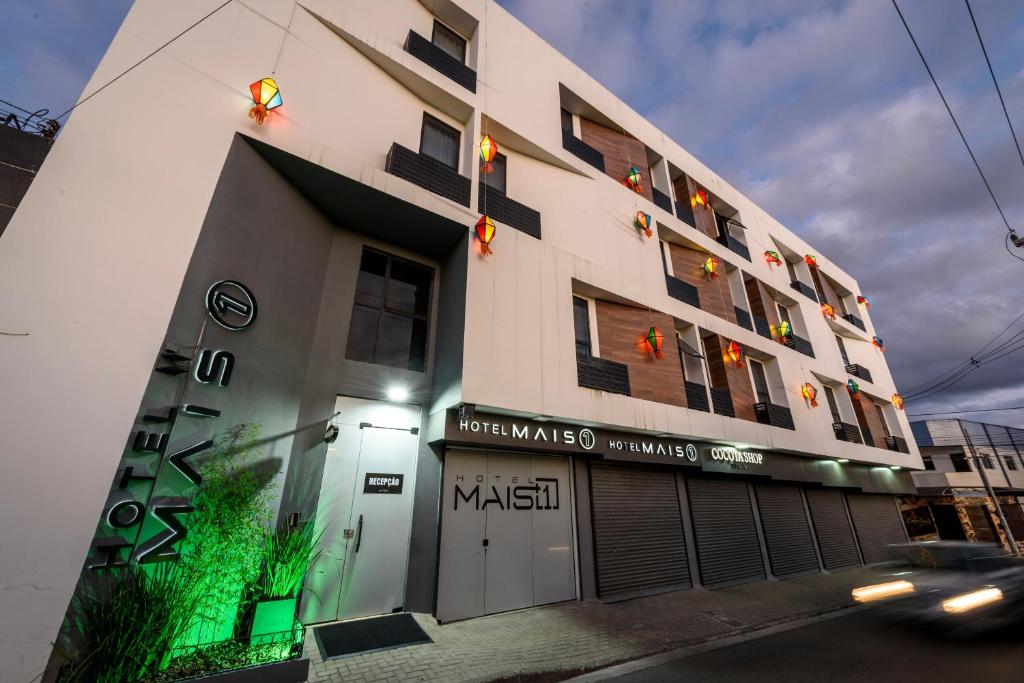a building with a sign on the side of it at Hotel Mais1 in Campina Grande