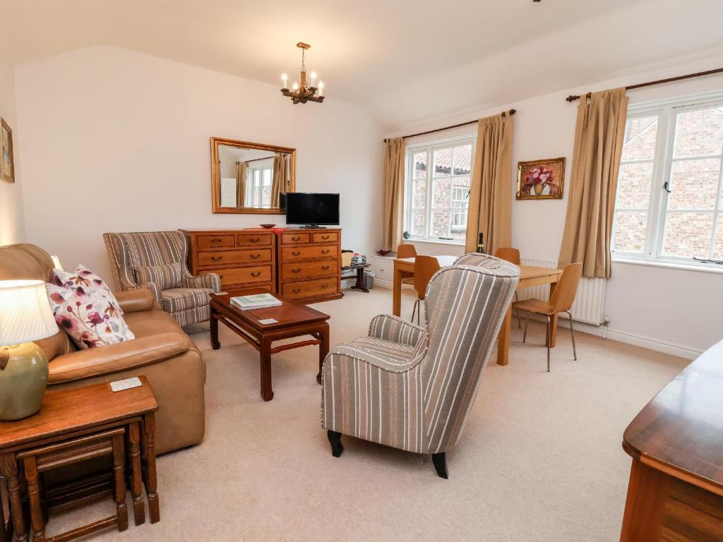 a living room with a couch and chairs and a table at 6 Granary Court in York