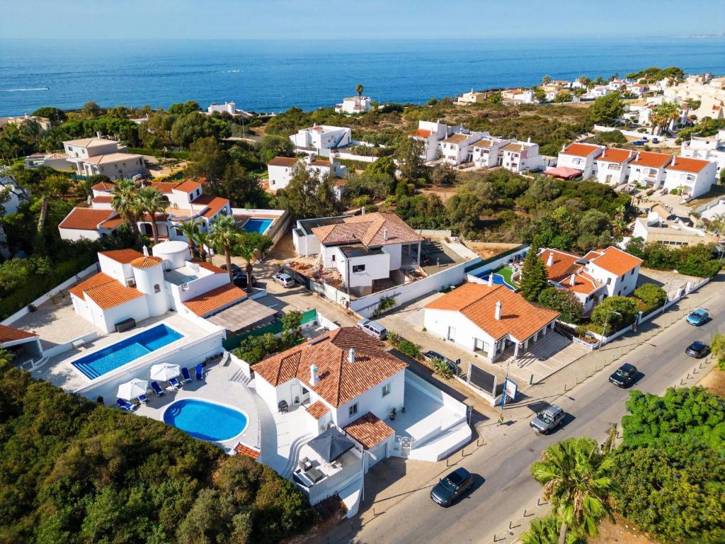 an aerial view of a village with houses and the ocean at Casa Pachorrenta in Carvoeiro