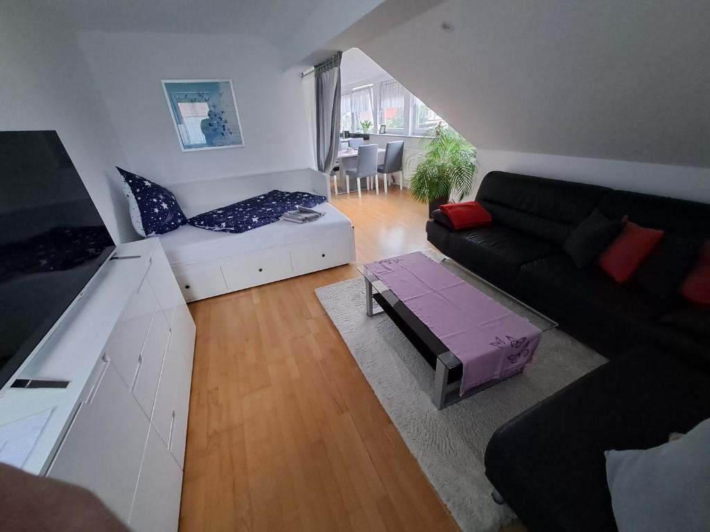 a living room with a couch and a table at Ferienwohnung-Vetter in Bodelshausen
