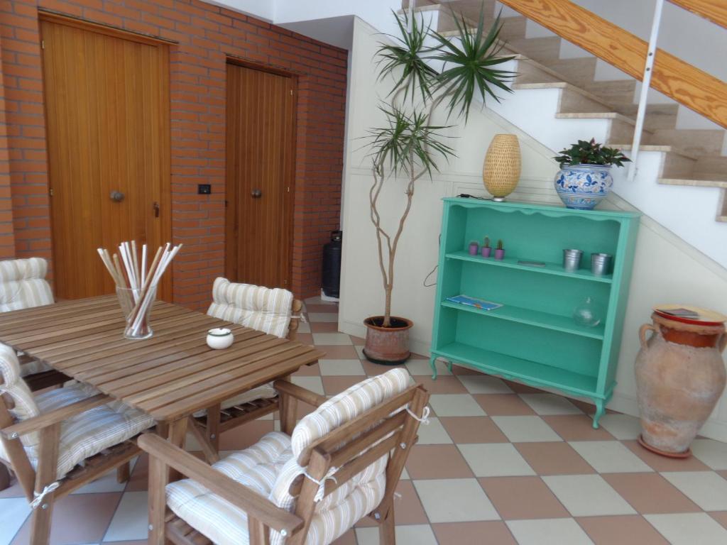 a dining room with a wooden table and chairs at Akron B&B in SantʼAlessio Siculo