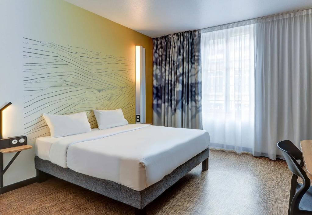 Ένα ή περισσότερα κρεβάτια σε δωμάτιο στο B&B HOTEL Dijon Centre