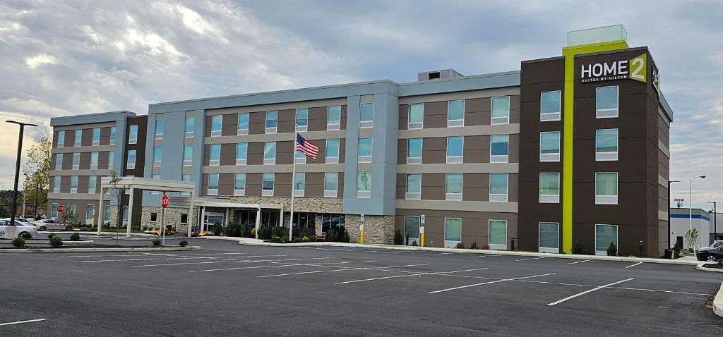 a hotel building with a home depot sign in a parking lot at Home2 Suites By Hilton Allentown Bethlehem Airport in Bethlehem