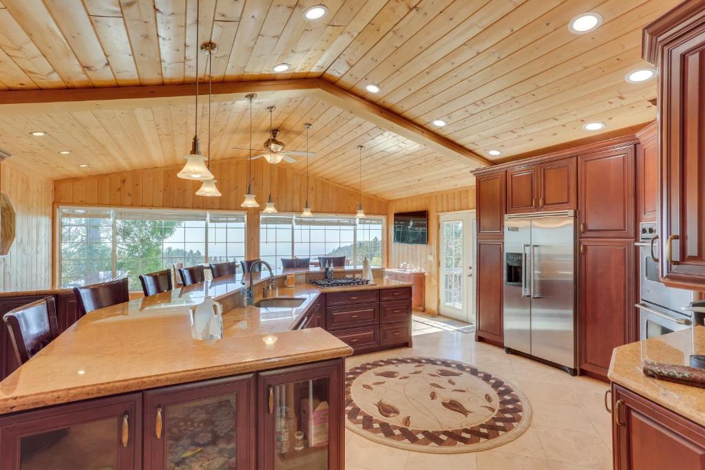 a large kitchen with wooden ceilings and wooden cabinets at Spacious Running Springs Home with Mountain Views in Running Springs