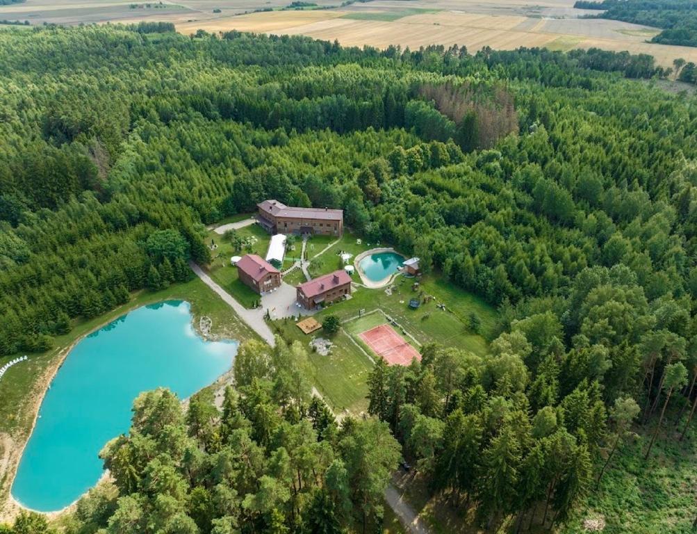 an aerial view of a house and a lake at Vila Forest Resort 