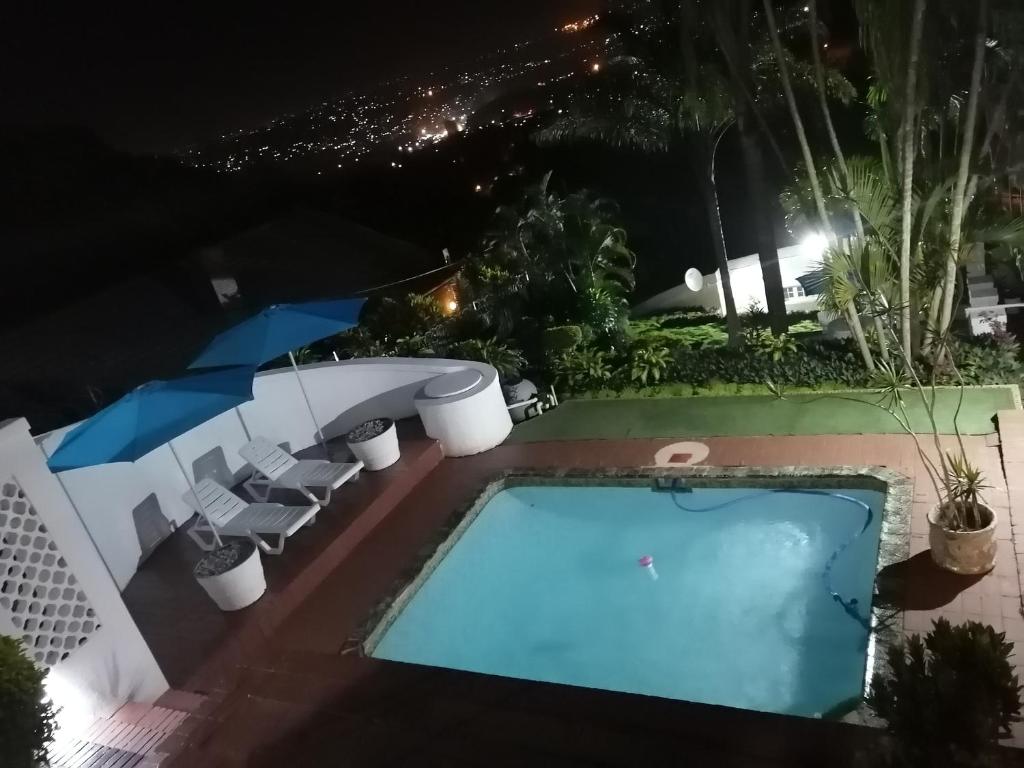 a swimming pool at night at Manor Family in Durban