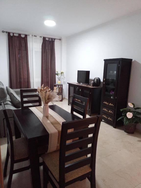 a living room with a dining room table and chairs at apartamento Castilla in Almodóvar del Río