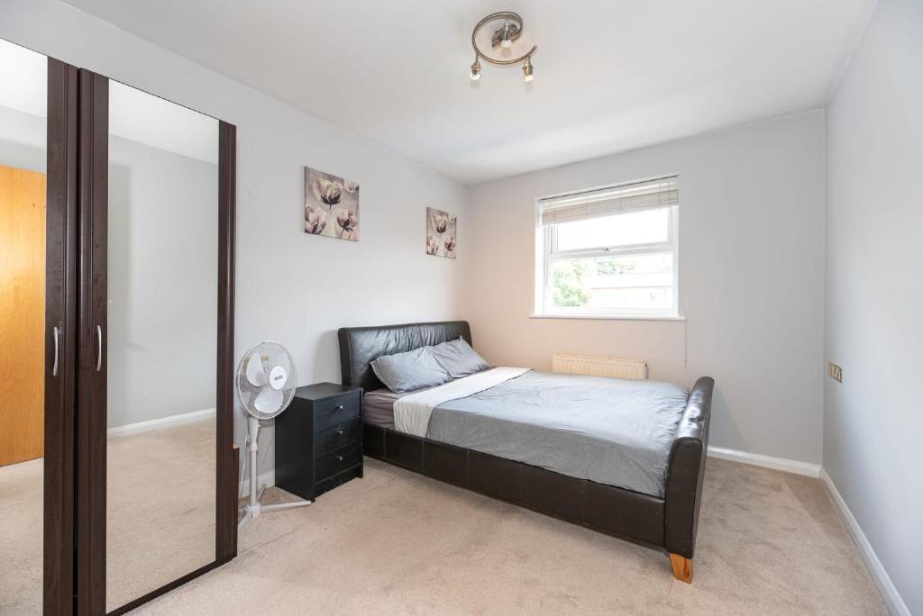 a bedroom with a bed and a window and a mirror at En-suite Double Room (Private bathroom) Central London in London
