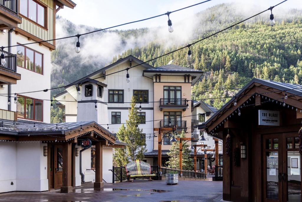 a town in the mountains with buildings at The Blake Residences in Taos Ski Valley
