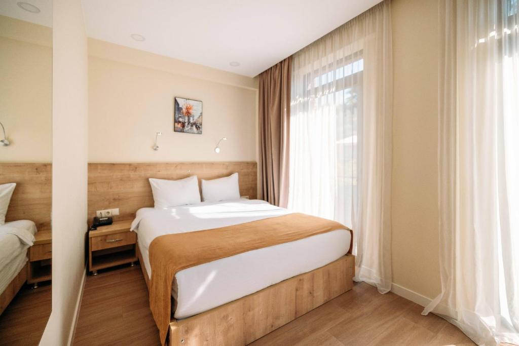 Postel nebo postele na pokoji v ubytování Atrium Boutique Hotel