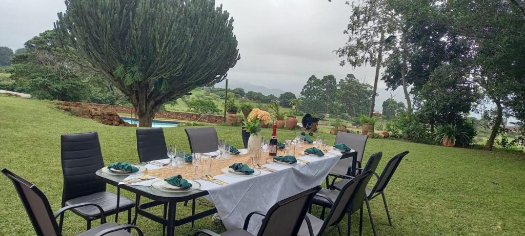 a table set up for a meal in a garden at Crest Farm Cottage in Waterfall