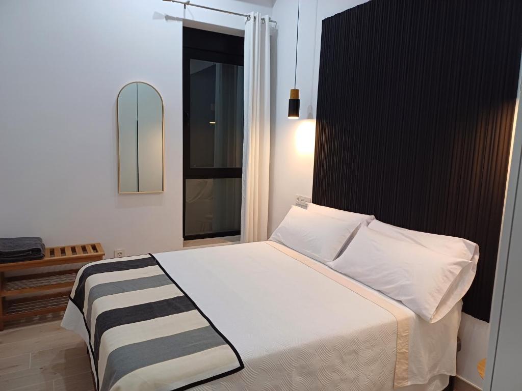a bedroom with a bed with a black and white blanket at Colon 13 in Zamora