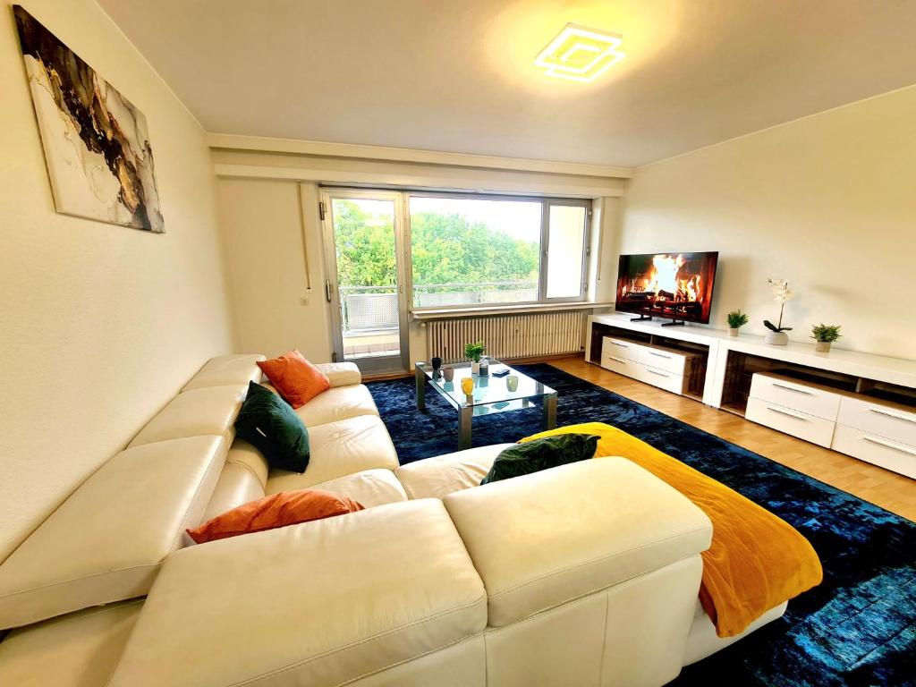ein Wohnzimmer mit einem weißen Sofa und einem TV in der Unterkunft Large 2 Bedrooms in Center with Terrace & Parking-41b in Luxemburg (Stadt)