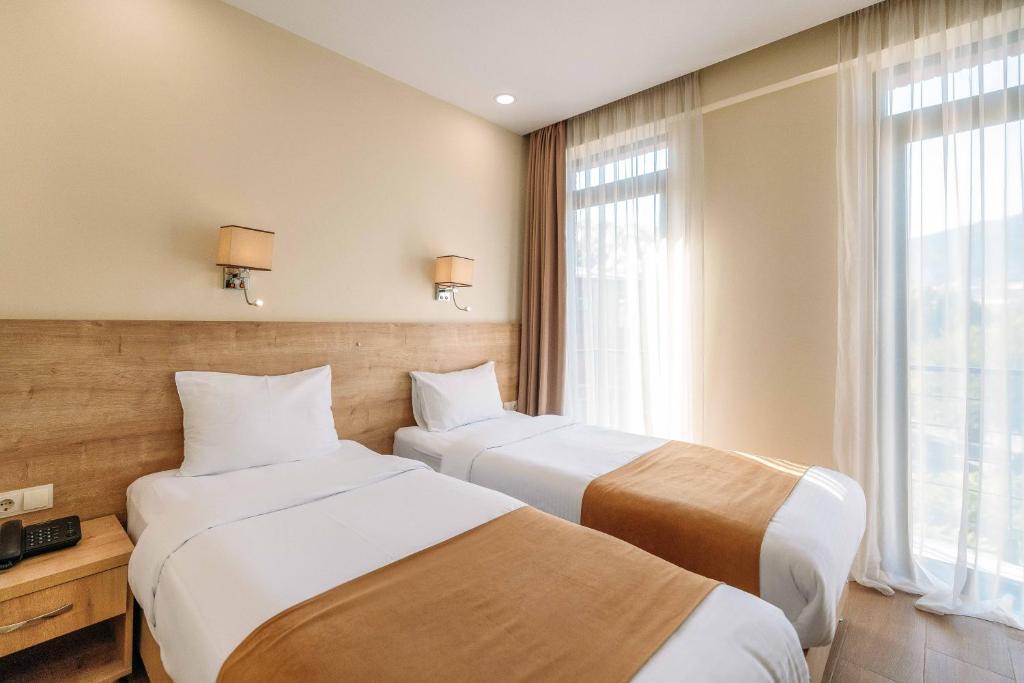 Postel nebo postele na pokoji v ubytování Atrium Boutique Hotel