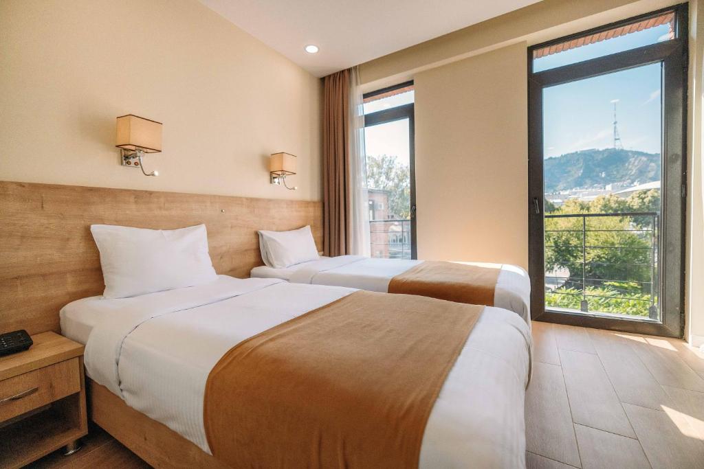 Postel nebo postele na pokoji v ubytování Atrium Boutique Hotel