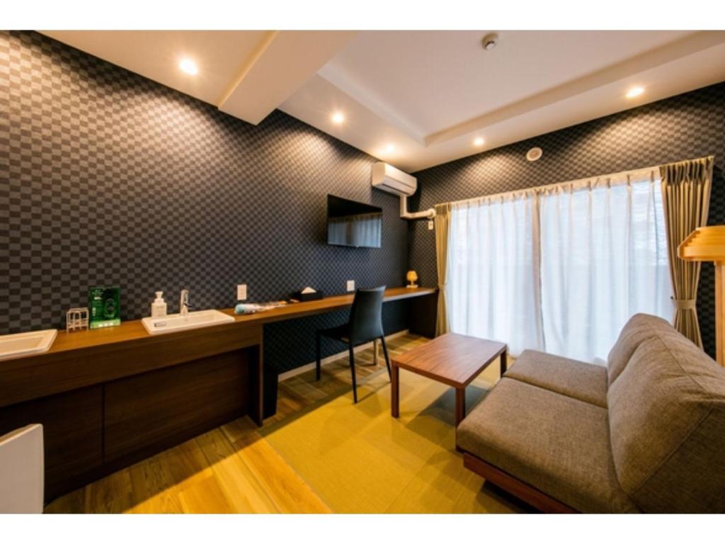 a living room with a couch and a desk at VILLA KOSHIDO KOTONI - Vacation STAY 49521v in Sapporo