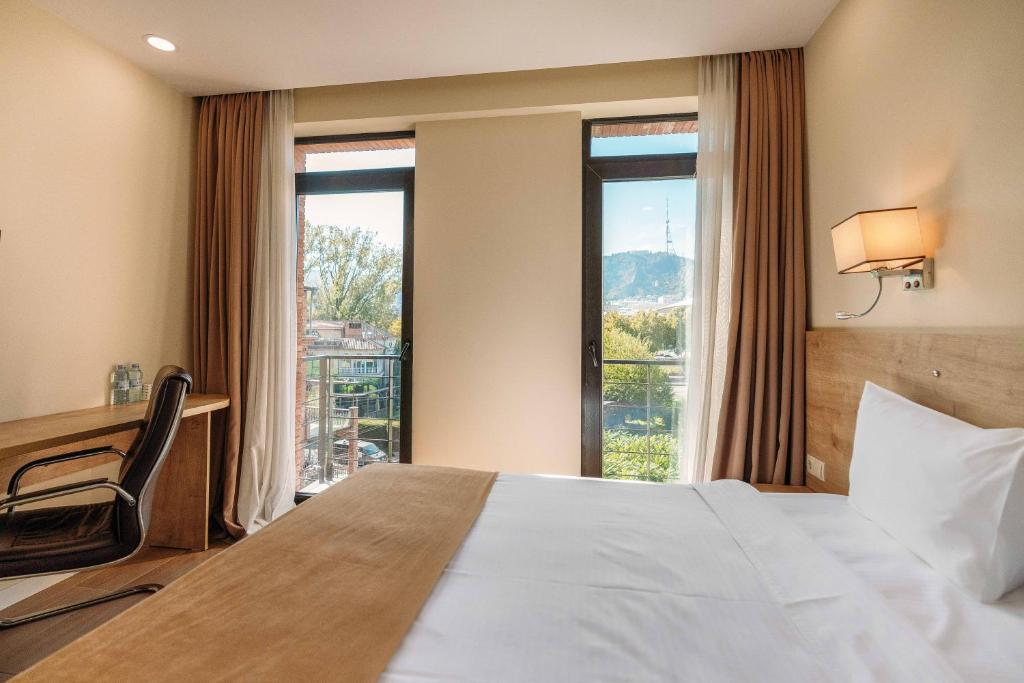 Postel nebo postele na pokoji v ubytování Atrium Boutique Hotel