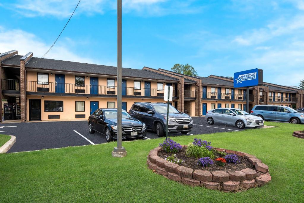 a hotel with cars parked in a parking lot at Americas Best Value Inn Laurel in Laurel