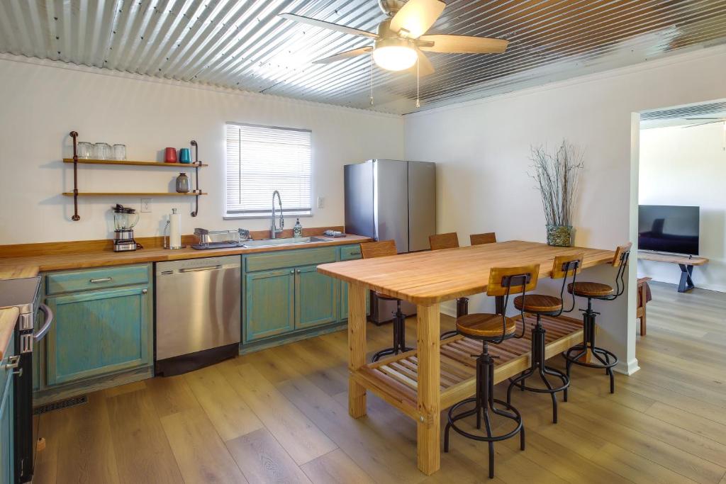 een keuken met groene kasten en een houten tafel bij Rustic Whitwell Home with Grill, Near State Parks! in Whitwell