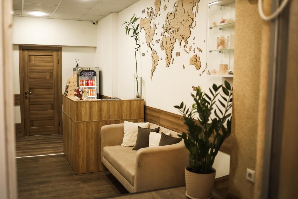 a waiting room with a couch and a world map on the wall at Міні-Готель Білий Квадрат in Kyiv