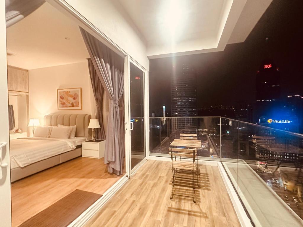 a bedroom with a bed and a view of a city at Quill Suites KLCC in Kuala Lumpur