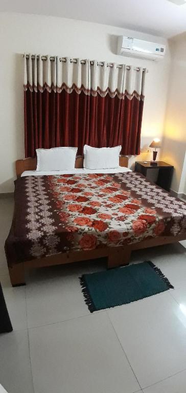 a bedroom with a bed with a red curtain at Service Apartment at Brookefield in Bangalore