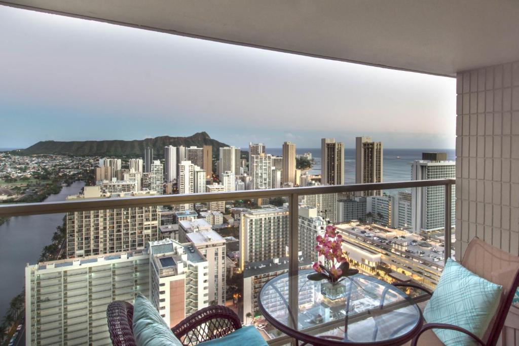 a balcony with a view of a city at Island Colony 4309 - 30-Night Minimum in Honolulu