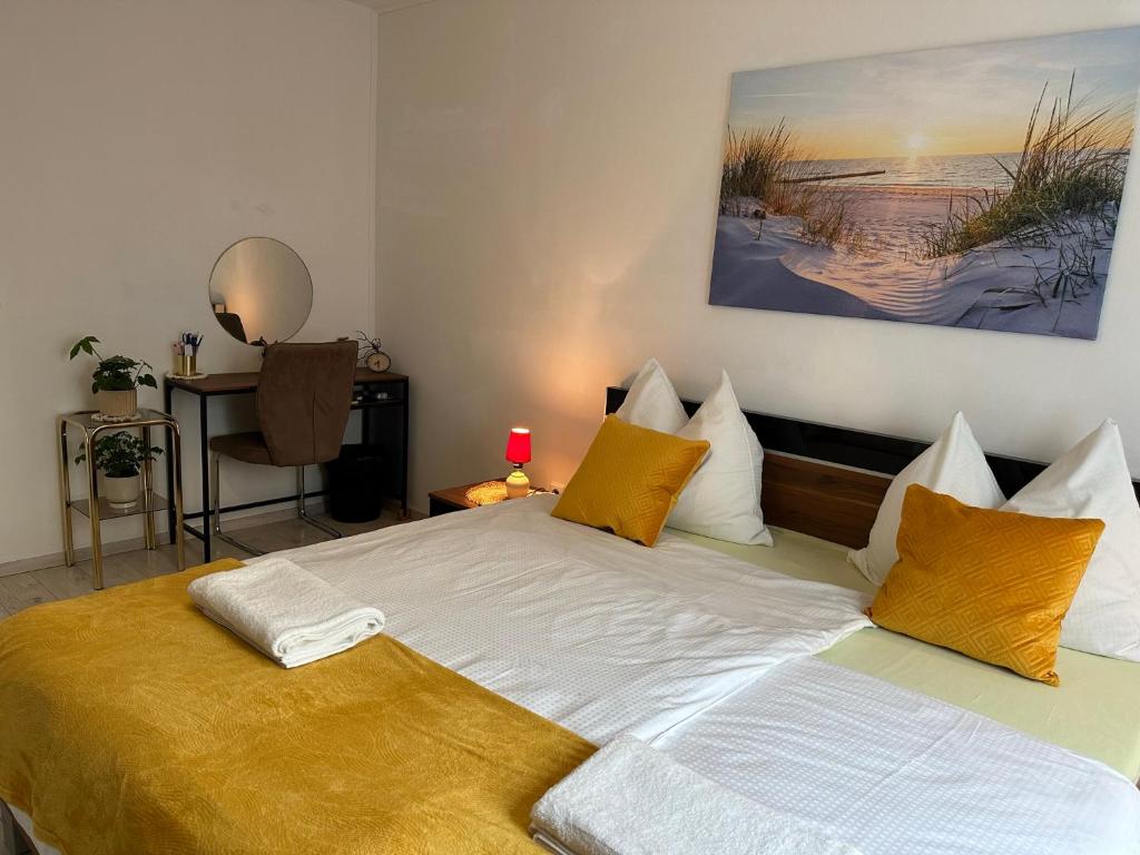 a bedroom with a large bed with yellow pillows at Central Station Comfort, Your Cozy Home with free Parking in Salzburg