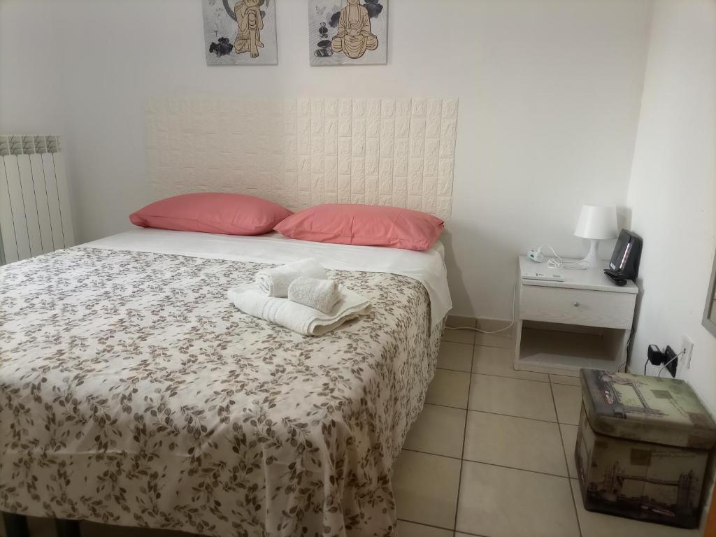 a bedroom with a bed with two towels on it at La Villetta in Rende