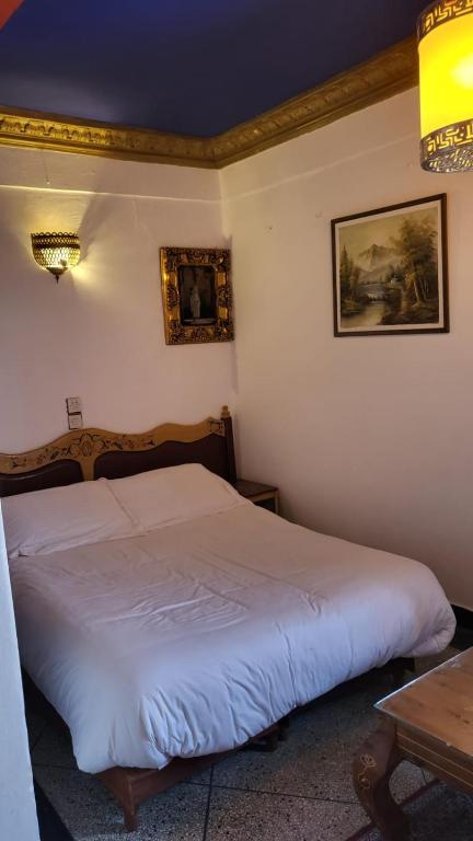 Postel nebo postele na pokoji v ubytování Hotel Sahara