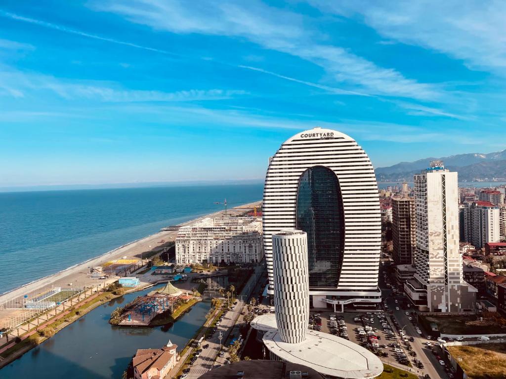 a view of a tall building next to the ocean at Orbi sity panorama in Angisa