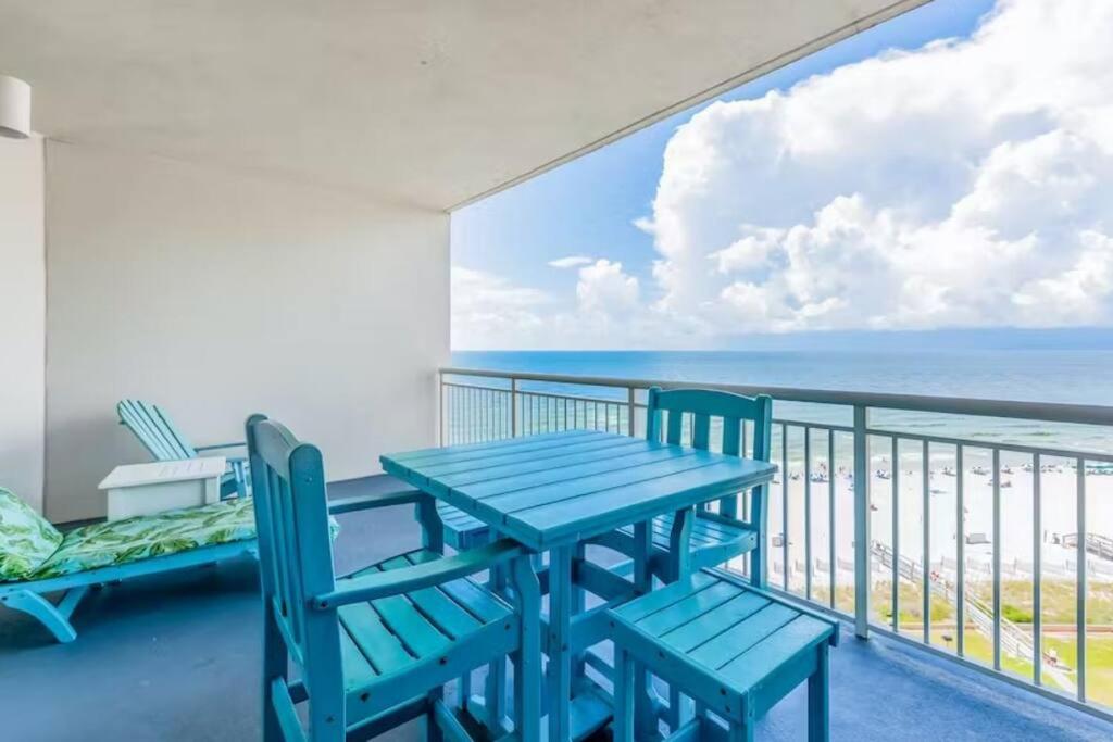a blue table and chairs on a balcony with the ocean at Palacio Unit 805 in Pensacola