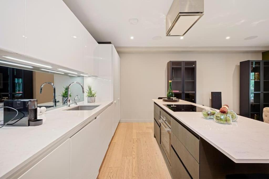 a kitchen with white counters and a large counter top at Battersea Luxury Apartment, Private, Independent Entrance, Central in London