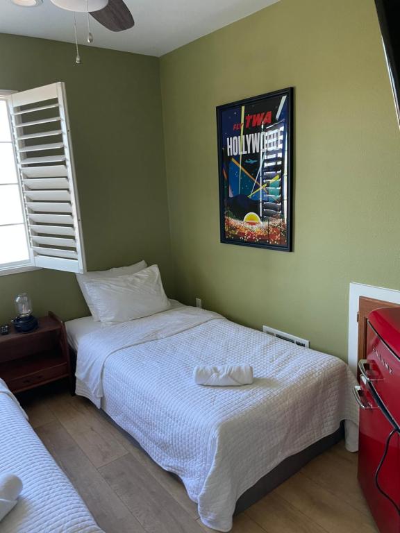 Dormitorio con cama y póster en la pared en Private Room in Los Angeles LA with TV & WIFI & AC & View of Hollywood Sign & Private Fridge & Shared Kitchen!!! en Los Ángeles