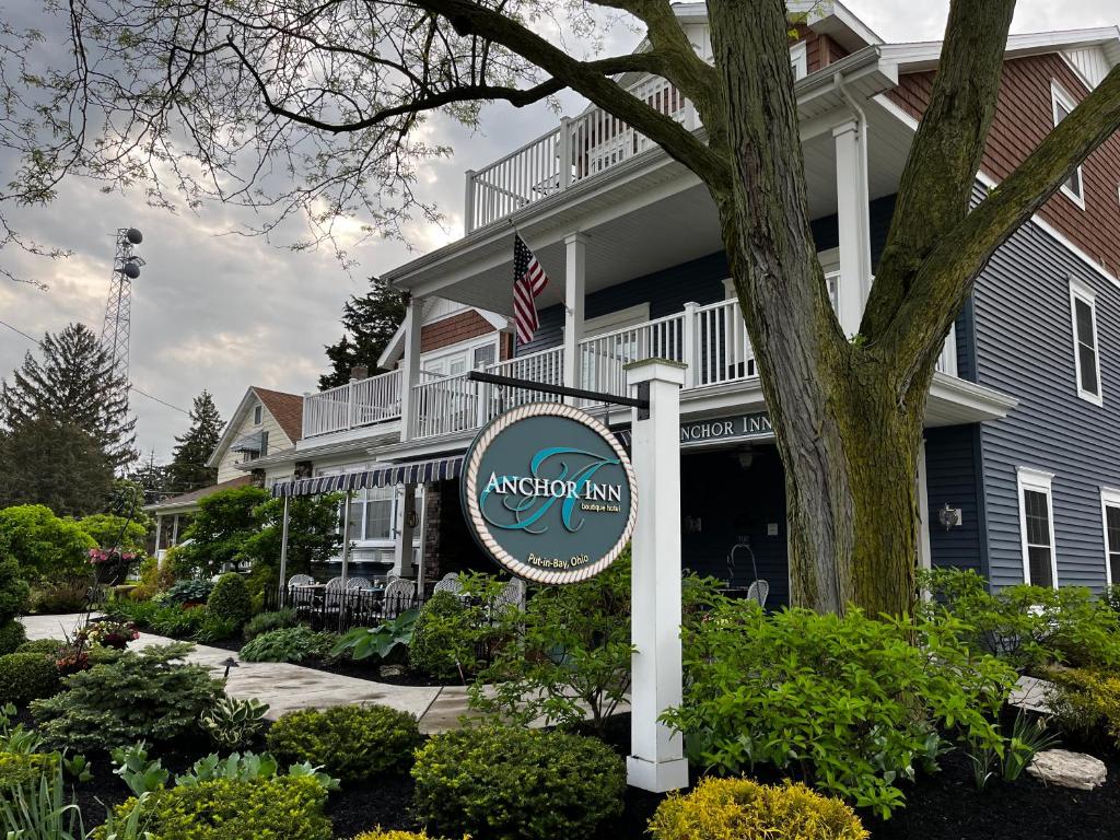 a sign for anantippi inn in front of a building at Anchor Inn Boutique Hotel in Put-in-Bay