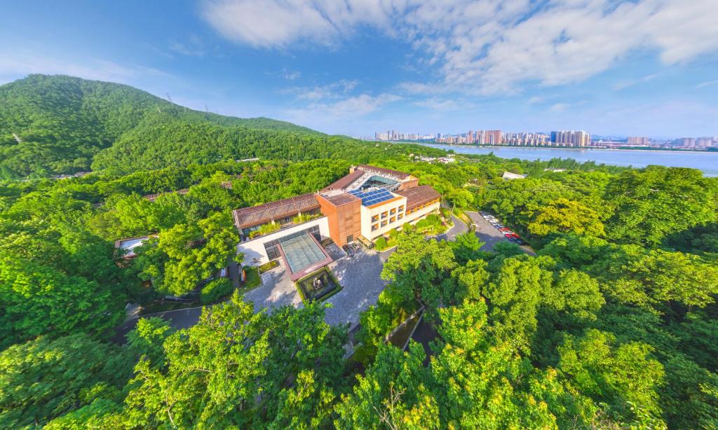 an aerial view of a building in the middle of a forest at Millennium Resort Hangzhou in Hangzhou